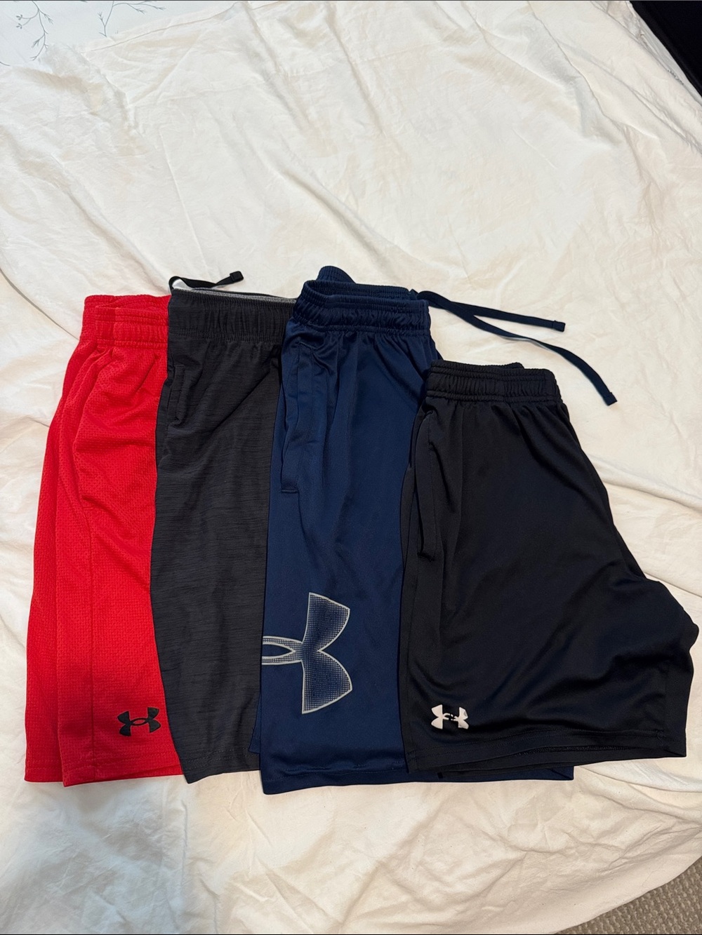 4 pairs - 3 Under Armour Men’s Athletic Shorts and 1 Old Navy Shorts